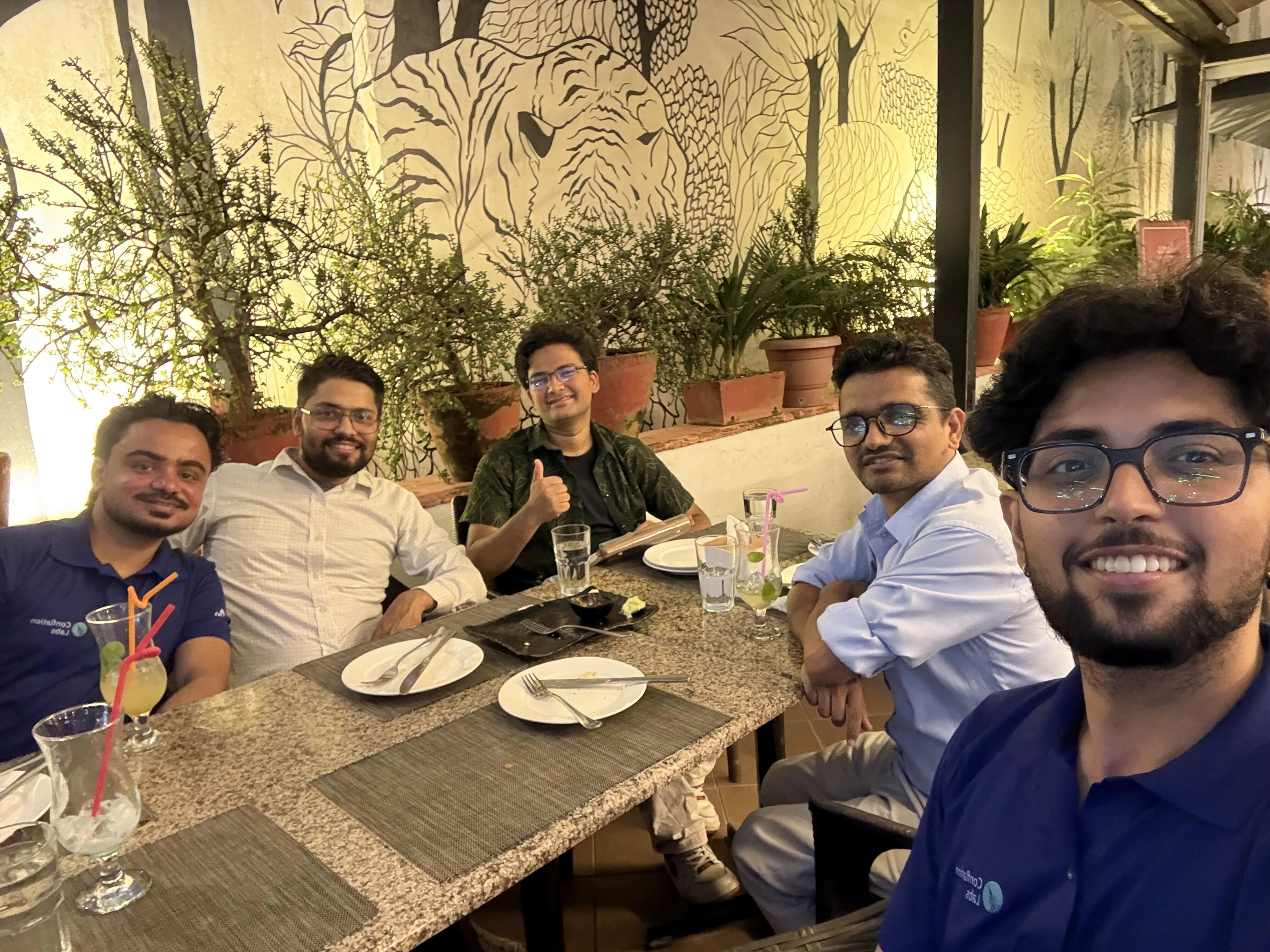 The team sharing a Dashain dinner and smiling at the camera